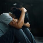 Woman with PTSD huddled in the fetal position_s