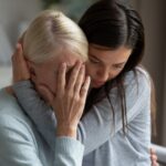 woman holding old woman in her arms_s