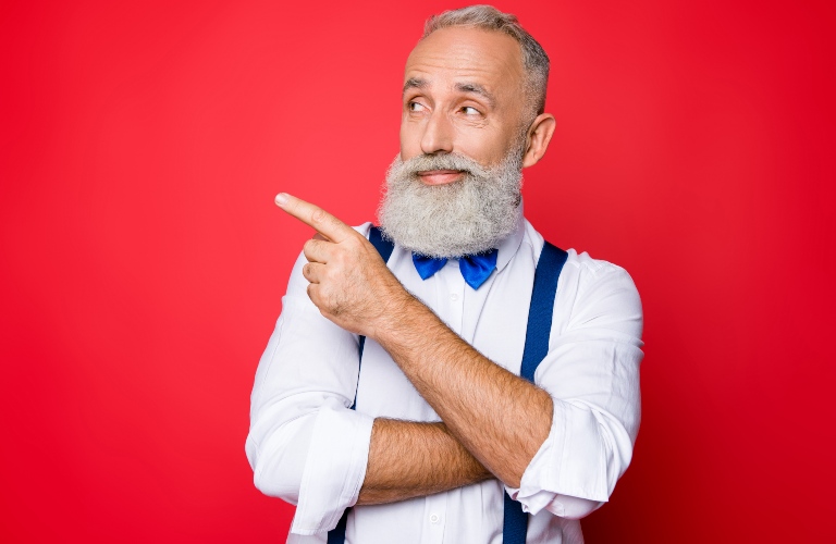 Older gentleman pointing to the left