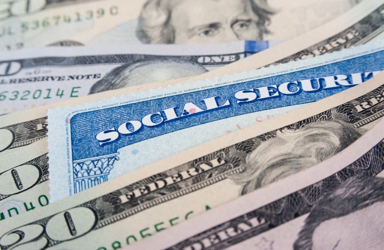 Social security card and American money dollar bills close up concept