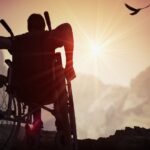 Person in a wheelchair at sunset_s