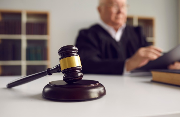 gavel with a judge in the background