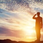 Soldier saluting in front of setting sun_s