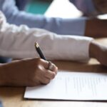 Person filling out SSDI paperwork_s