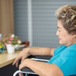 Woman in a wheelchair looking at documents_s