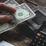 man holding money and a calculator_s