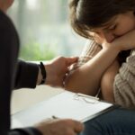 Doctor with notes talking to a woman_s