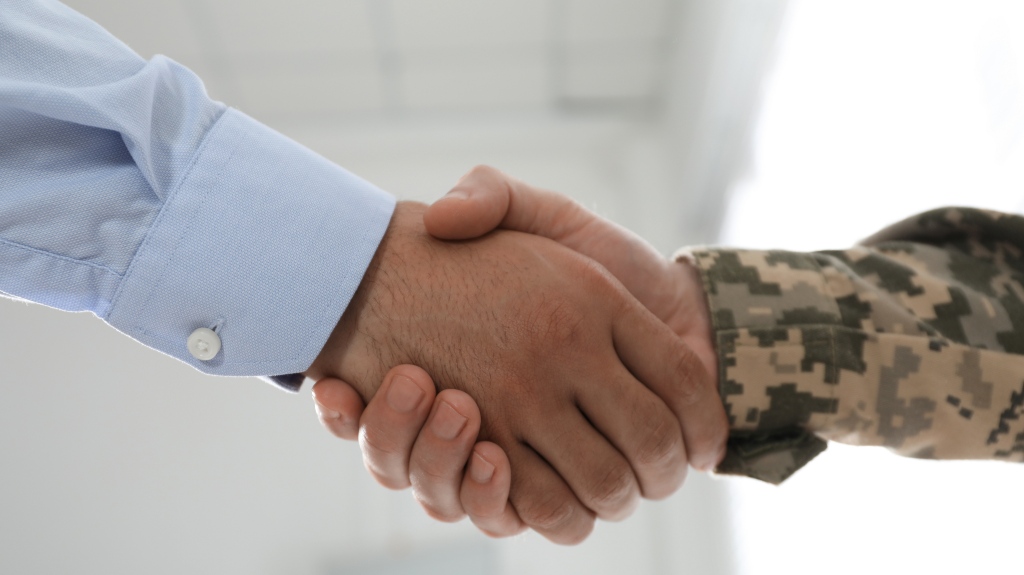 Man shaking hands with a soldier