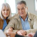 Old couple reviewing stuff on a computer_s