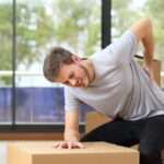Man with hurt back with boxes_s