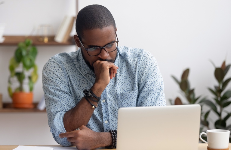 Man waiting at a computer