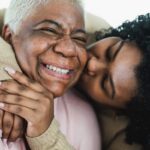 Woman kissing mother on the cheek_s