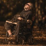 Man in a wheelchair on a leafy lane_u