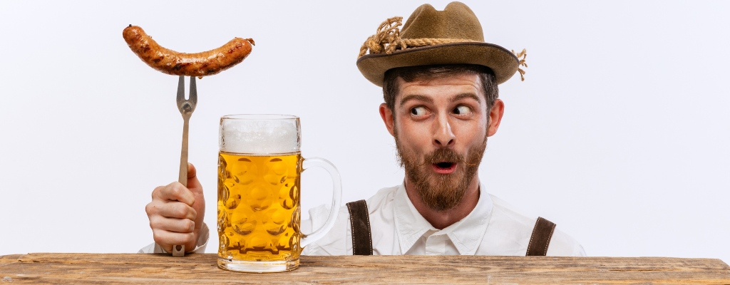 Man with a brat in a beer in German attire