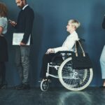 woman in a wheelchair waiting in a line_s