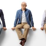 Men sitting on a ledge getting older left to right_s