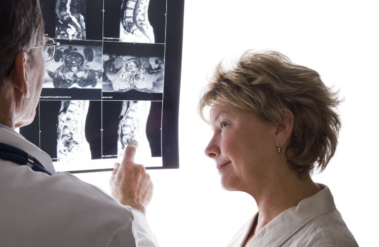 Doctor helping a woman review her x-rays