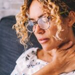 Woman holding neck in pain_s