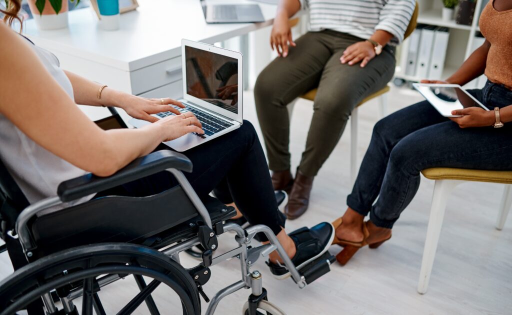 person in wheel chair with laptop