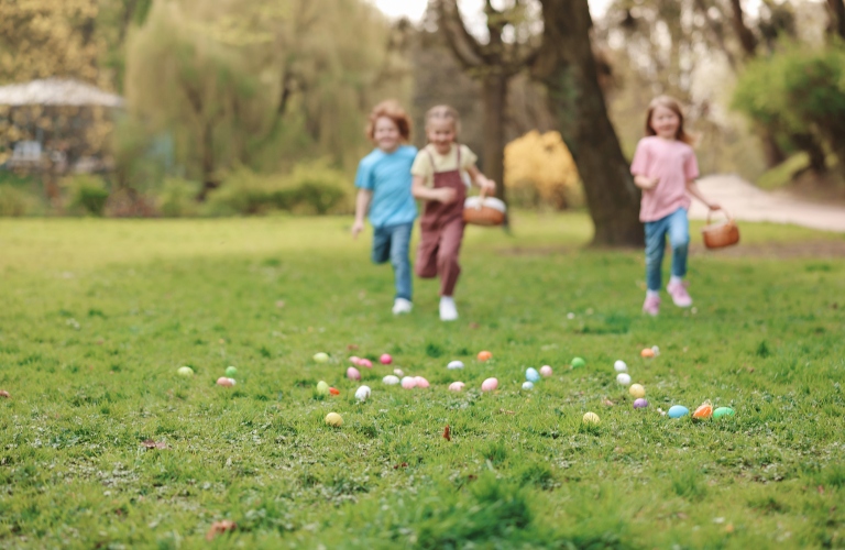 Little children hunting eggs outdoors