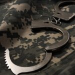 handcuffs on camouflage uniform