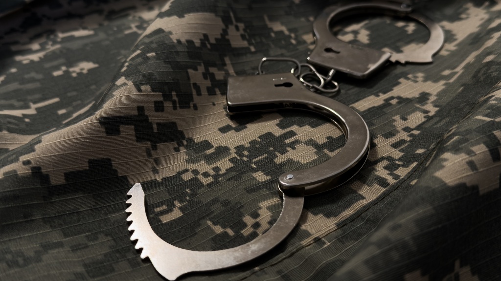 handcuffs on camouflage uniform