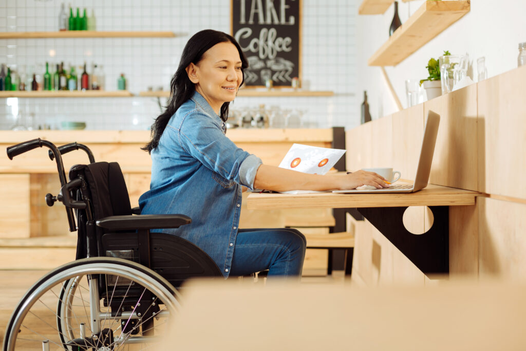 woman in a wheel chair on a laptop
