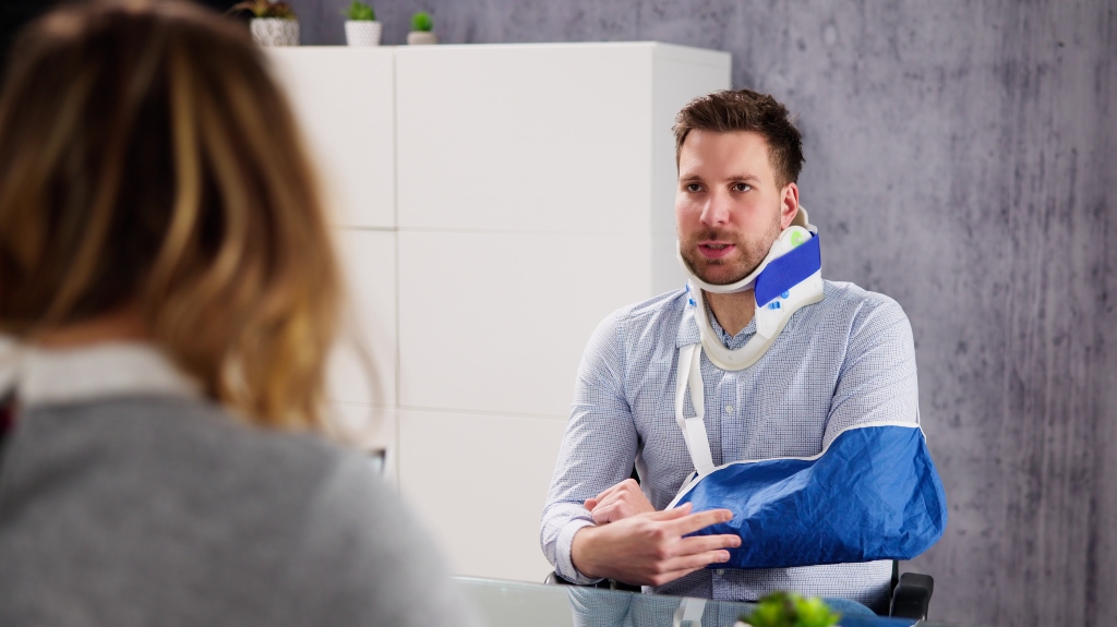 Injured man consulting with lawyer
