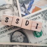 SSDI on dollars background_s