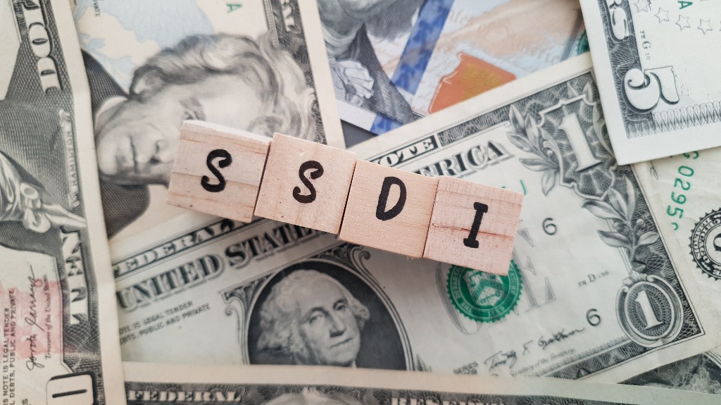 SSDI on dollars background