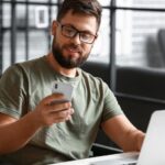 Soldier in wheelchair using mobile phone_s