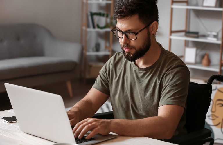 veteran in wheelchair is using laptop