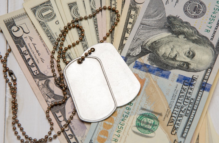 An army medallion rests on money