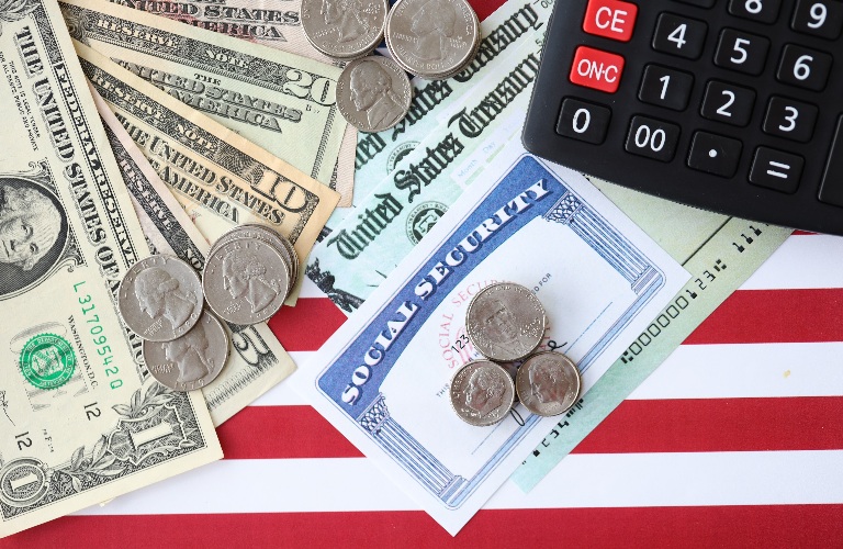 US dollars,social security number card and calculator on American flag