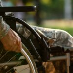 Young soldier in wheelchair outdoors_s